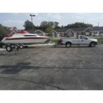 our rinker on trailer behind my truck.jpg