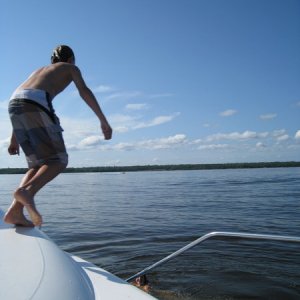 Kids diving off the boat