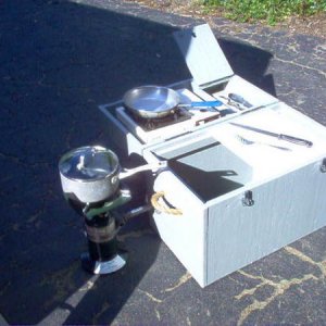 Galley opened up. Small saute grill on top with a compartment to the immediate right to hold knifes, spatula, etc. Coleman stove secured on left side.