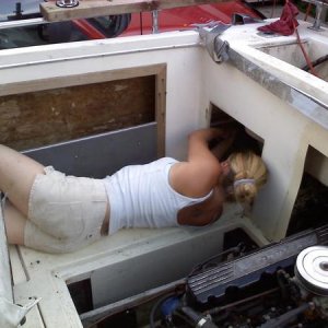 My wife installing the new bilge system. At least when I get frustrated and have to take a break, I have this to look at..;)