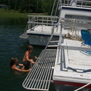 Kadry and friends jumping into the water from the back of the houseboat. Fun weekend!