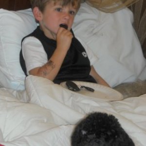 Kadry and Oreo relaxing in the houseboat watching cartoons, early morning.