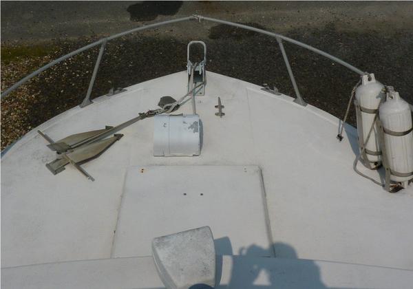 Fore deck. Working anchor winch and search light. Deck hardware appears to be solid