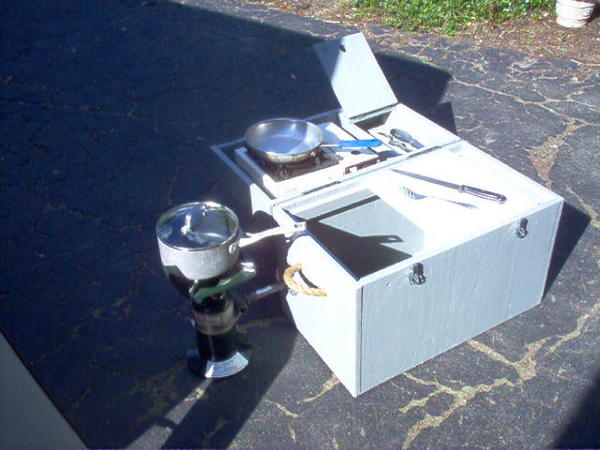 Galley opened up. Small saute grill on top with a compartment to the immediate right to hold knifes, spatula, etc. Coleman stove secured on left side.