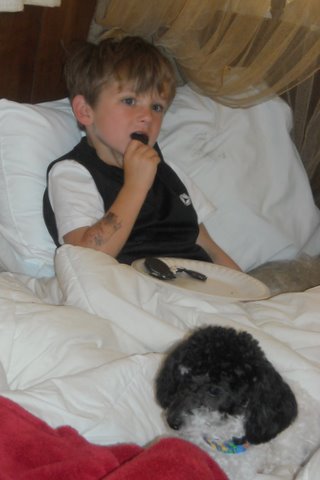 Kadry and Oreo relaxing in the houseboat watching cartoons, early morning.